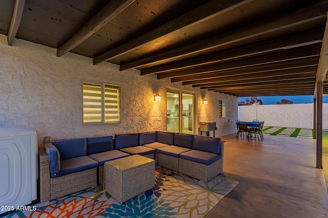 view of patio featuring an outdoor living space, washer / clothes dryer, outdoor dining space, and fence