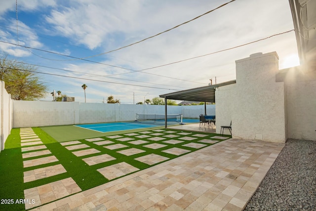 view of yard with a fenced backyard and a tennis court