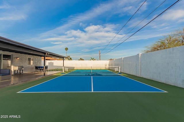 view of sport court featuring fence