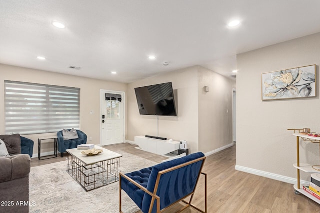 living room with recessed lighting, baseboards, visible vents, and wood finished floors