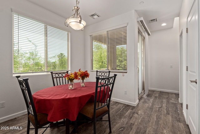 dining room featuring visible vents, wood finished floors, and a wealth of natural light
