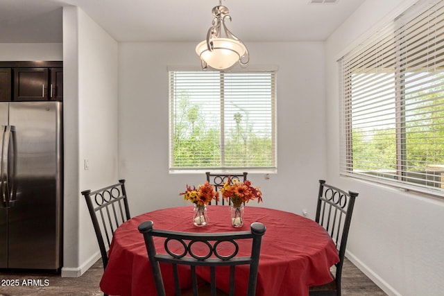 dining space with baseboards, dark wood-style floors, and visible vents