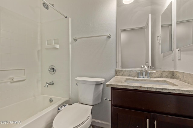 bathroom with vanity, bathtub / shower combination, and toilet