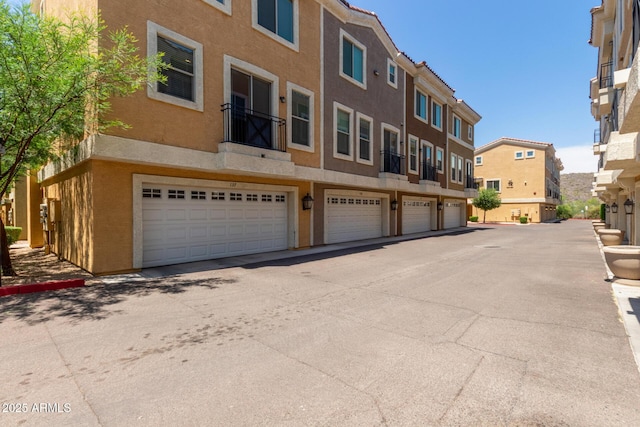 view of building exterior with a residential view and a garage