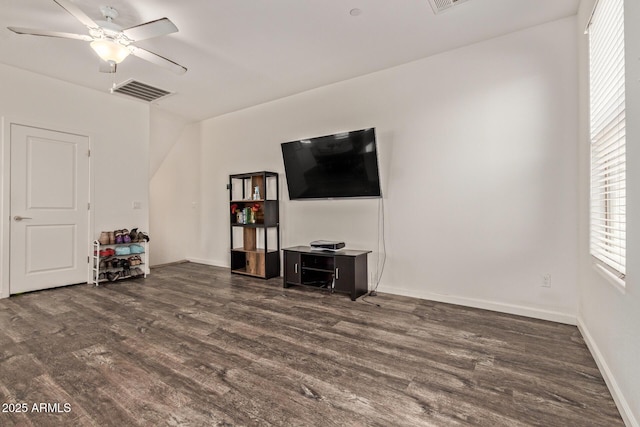 living area with a ceiling fan, baseboards, visible vents, and wood finished floors