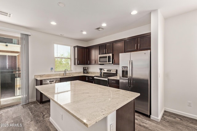 kitchen featuring visible vents, dark brown cabinetry, and stainless steel appliances
