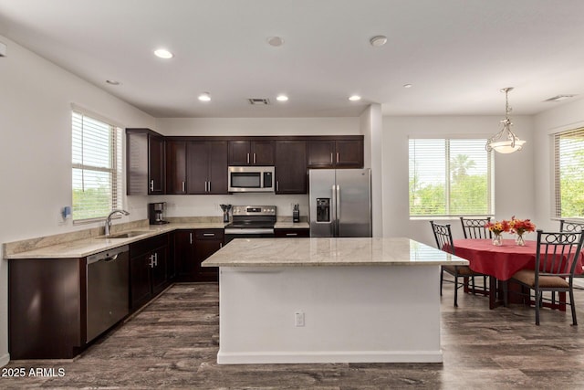 kitchen featuring a sink, dark wood-style flooring, dark brown cabinets, and stainless steel appliances