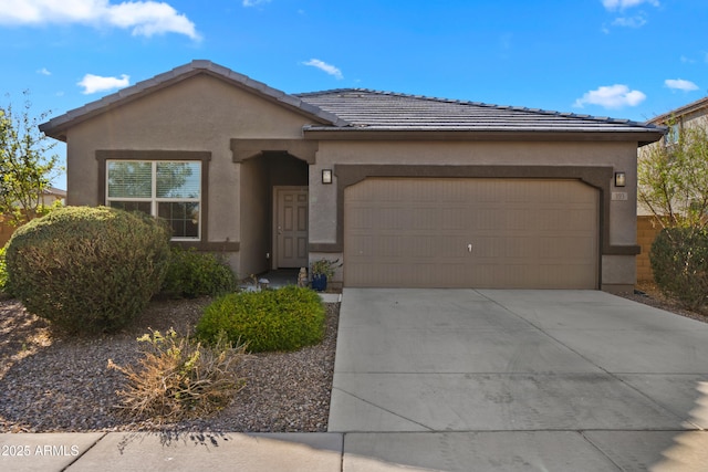 single story home featuring driveway, an attached garage, a tile roof, and stucco siding