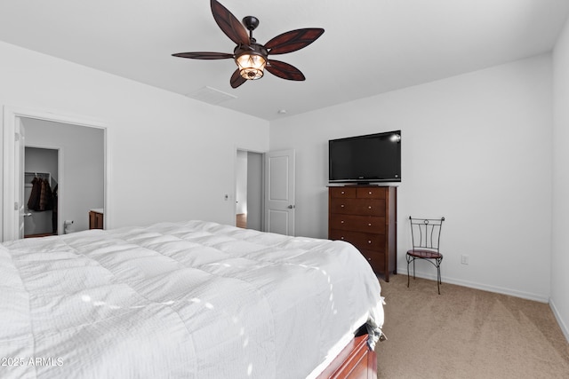 bedroom with baseboards, visible vents, a ceiling fan, light colored carpet, and a spacious closet