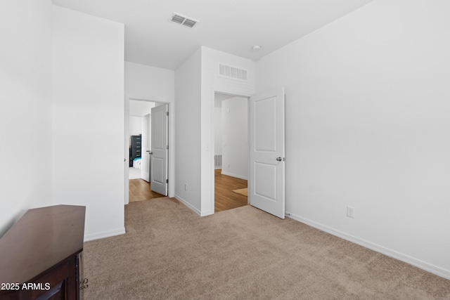 bedroom with carpet floors, visible vents, and baseboards