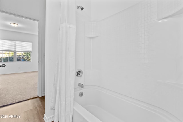 full bathroom with shower / bath combo and wood finished floors