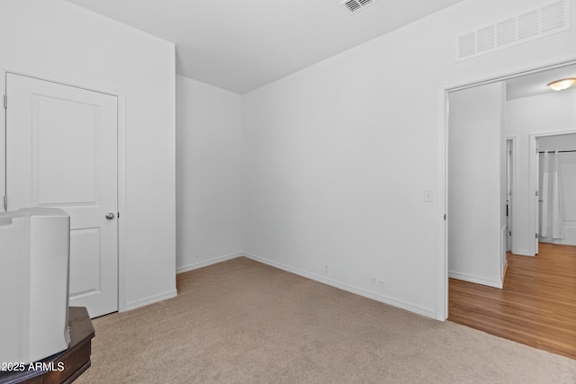 unfurnished bedroom featuring baseboards, visible vents, and carpet flooring