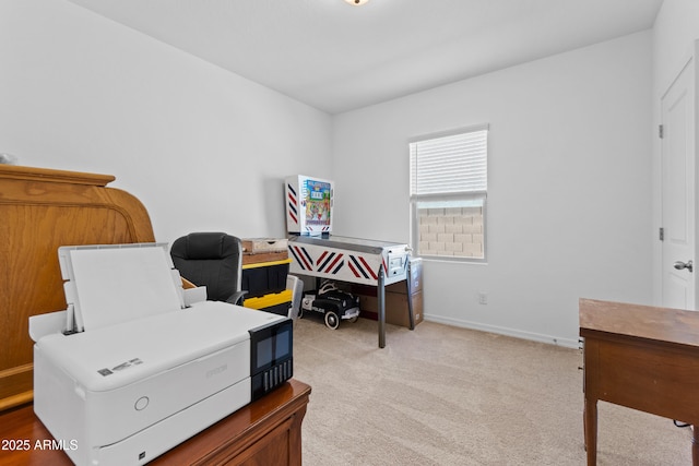 home office with light colored carpet and baseboards