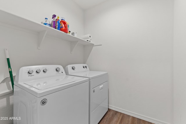 laundry area featuring laundry area, independent washer and dryer, baseboards, and wood finished floors