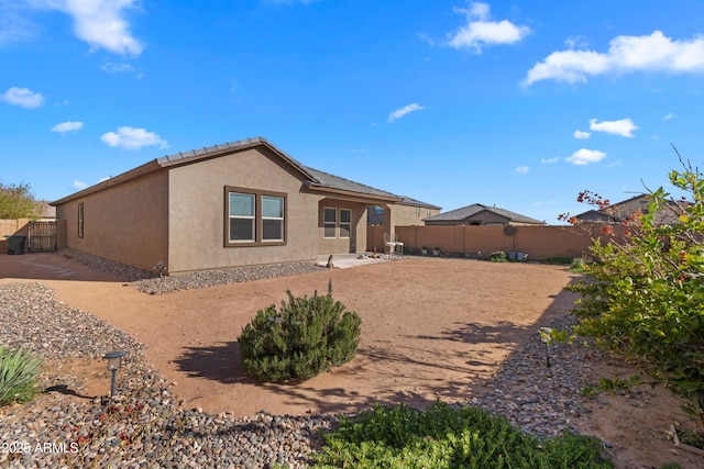 back of property with a patio area, a fenced backyard, and stucco siding