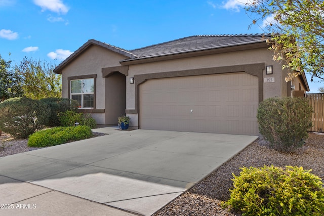 ranch-style house with stucco siding, concrete driveway, an attached garage, fence, and a tiled roof