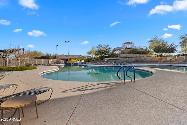 community pool featuring a patio and fence