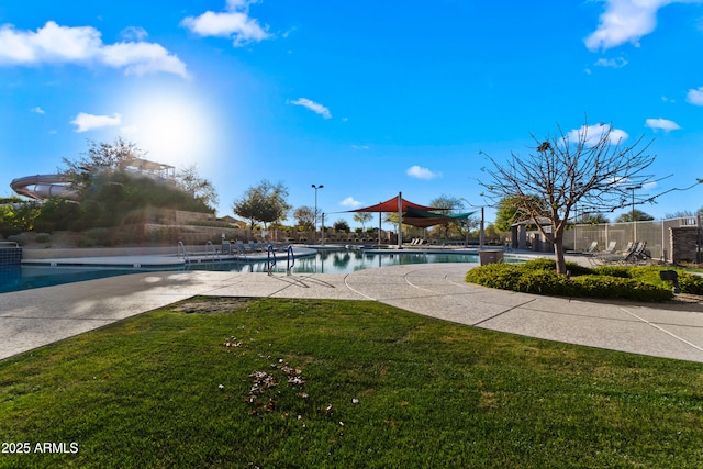 pool featuring a yard, fence, and a patio