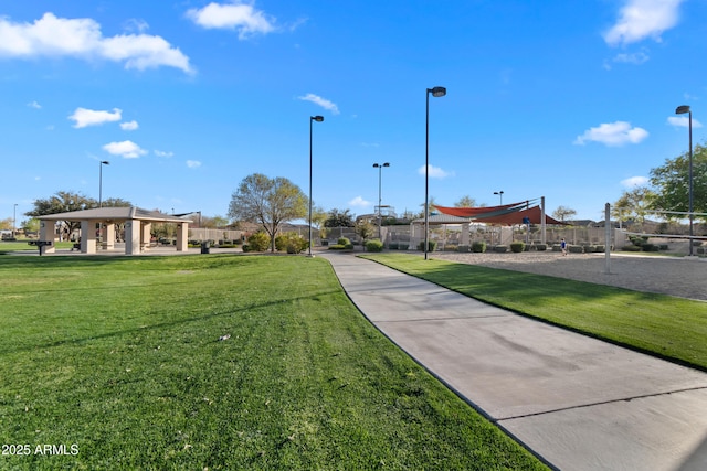 surrounding community with volleyball court, a lawn, and a gazebo