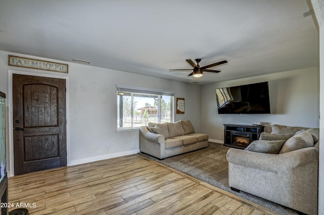 living room with light wood-type flooring and ceiling fan