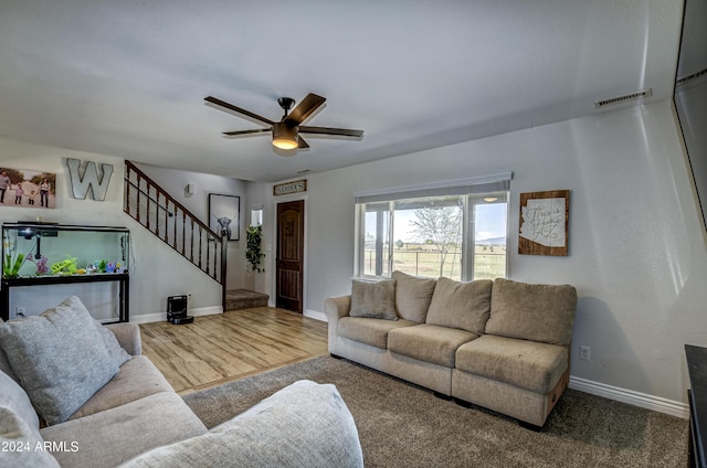 living room featuring ceiling fan and hardwood / wood-style flooring