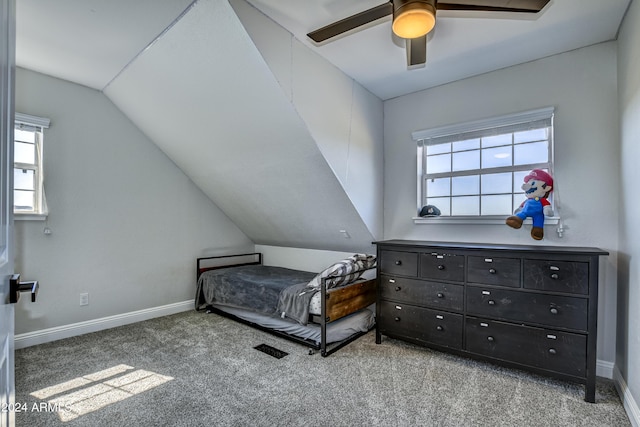 carpeted bedroom featuring vaulted ceiling and ceiling fan