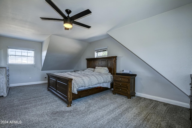 bedroom featuring dark colored carpet, ceiling fan, vaulted ceiling, and multiple windows