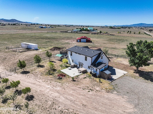 drone / aerial view featuring a mountain view and a rural view