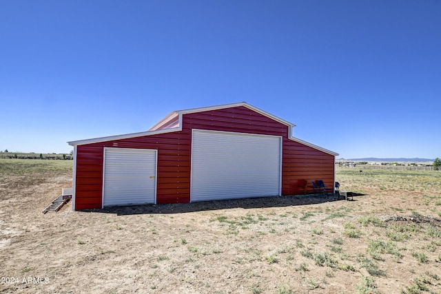 garage featuring a rural view