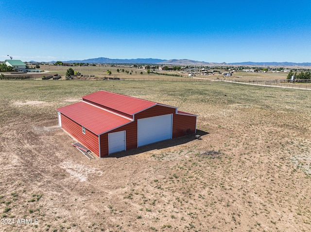 drone / aerial view featuring a mountain view and a rural view