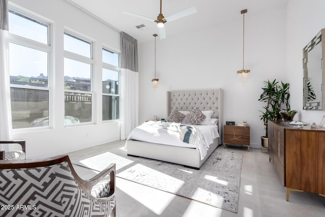 bedroom with a towering ceiling and ceiling fan