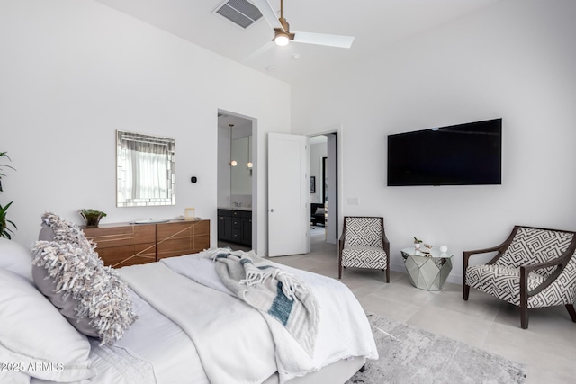 bedroom featuring a towering ceiling, ceiling fan, and ensuite bathroom