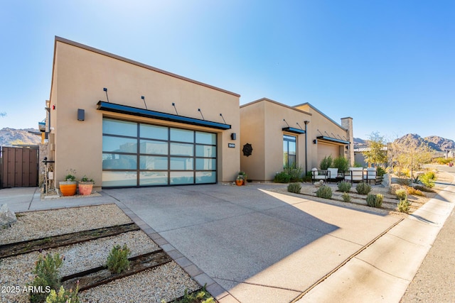 view of front facade with a mountain view and a garage