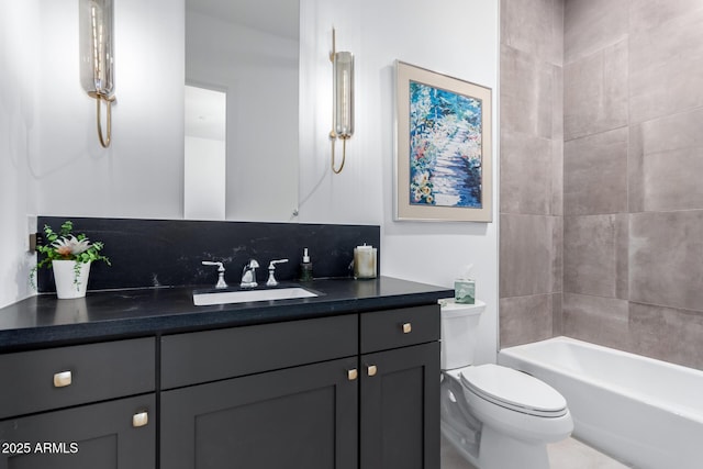 full bathroom with tasteful backsplash, tiled shower / bath, vanity, and toilet