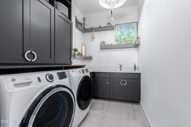 washroom featuring cabinets, separate washer and dryer, sink, and light tile patterned floors