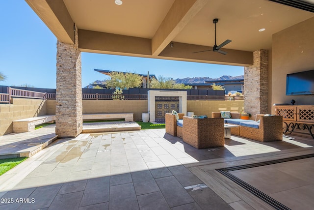 view of patio with outdoor lounge area and ceiling fan