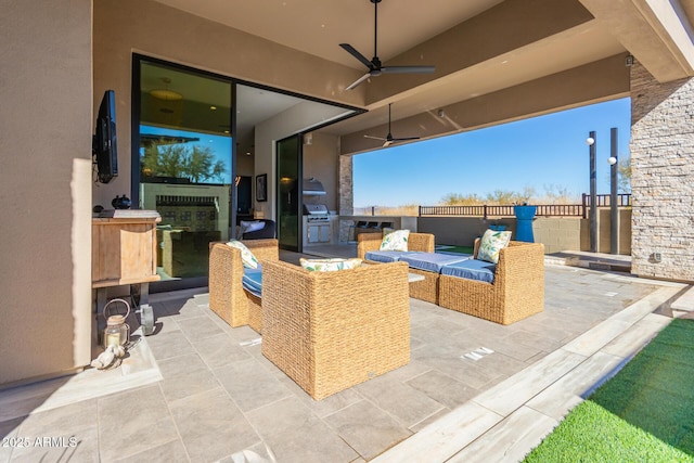 view of patio with ceiling fan, an outdoor kitchen, and area for grilling