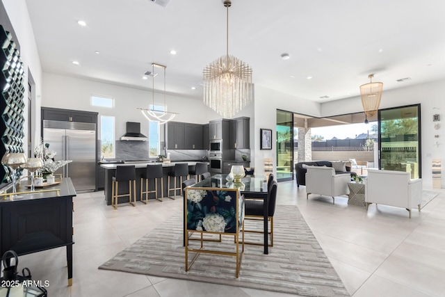 dining room with light tile patterned floors and a chandelier