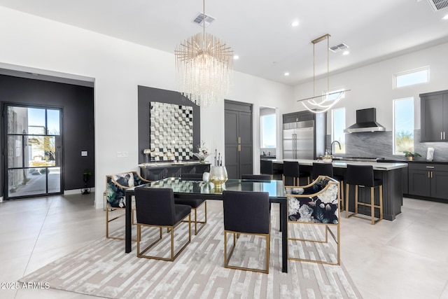 tiled dining room featuring an inviting chandelier