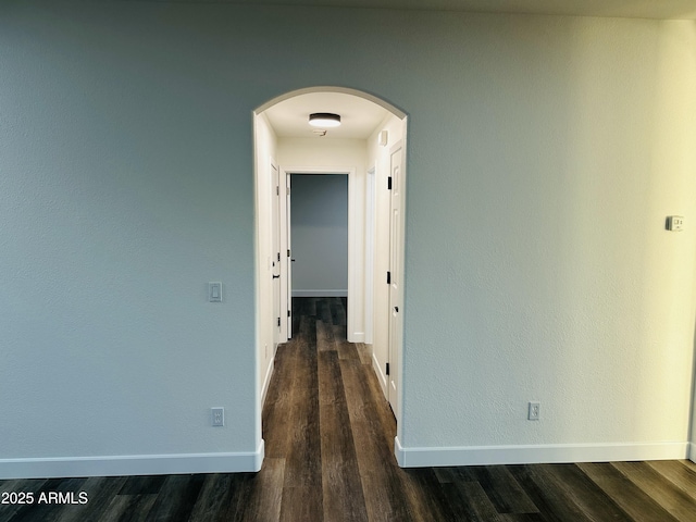 hallway with dark wood-type flooring