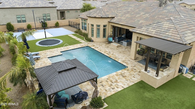 view of pool with a gazebo, a fenced backyard, a lawn, and a patio