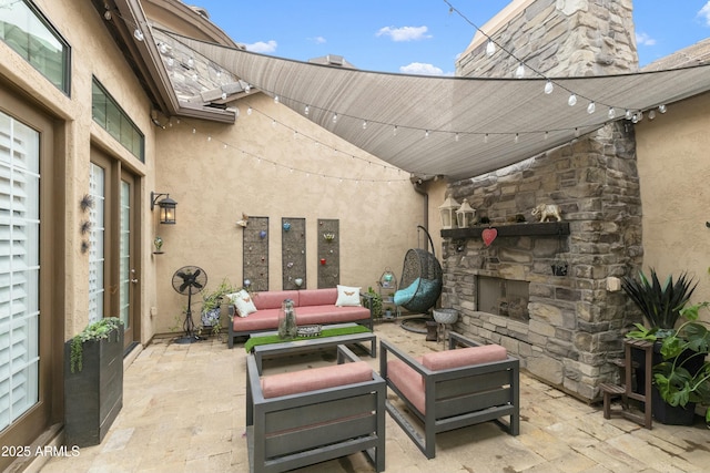 view of patio featuring an outdoor living space with a fireplace