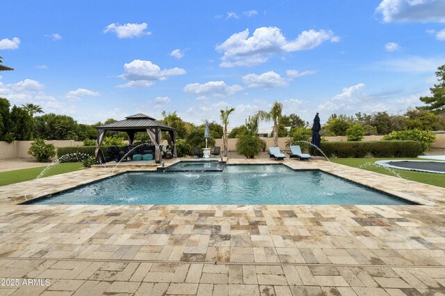 view of pool featuring a gazebo, fence, a pool with connected hot tub, and a patio