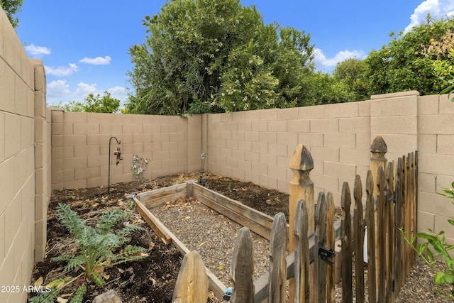 view of yard with a garden and a fenced backyard