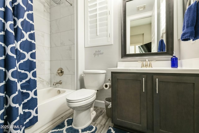 bathroom featuring visible vents, baseboards, toilet, shower / bath combo, and vanity