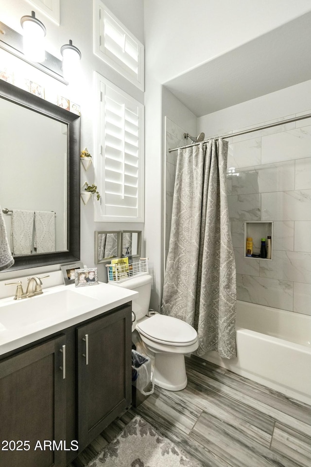 full bath with toilet, shower / bath combo, and vanity