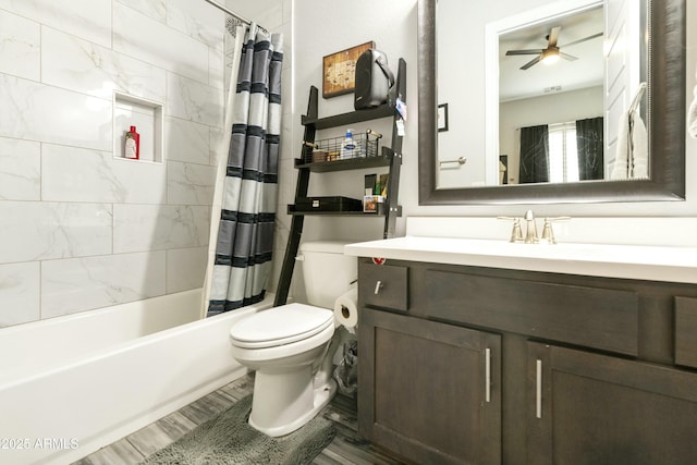 full bathroom with toilet, shower / tub combo with curtain, wood finished floors, ceiling fan, and vanity