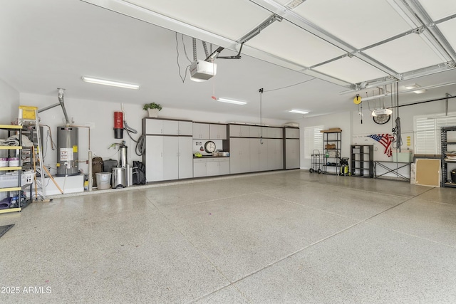 garage with water heater and a garage door opener