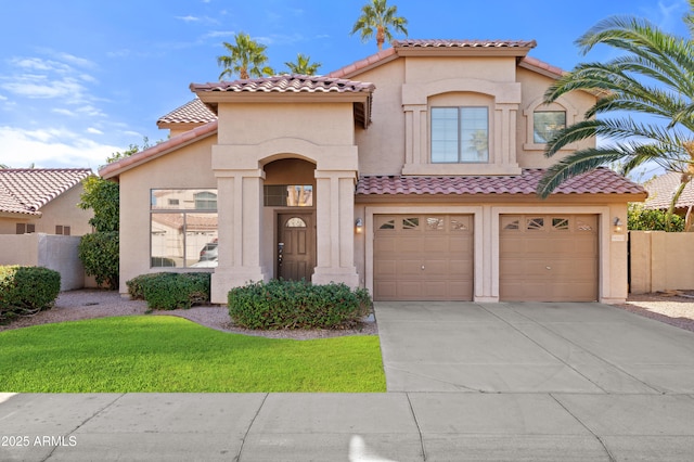 mediterranean / spanish-style house with a garage