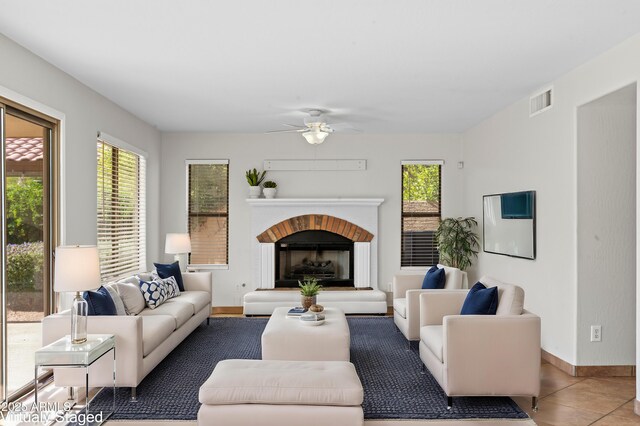 tiled living room with ceiling fan